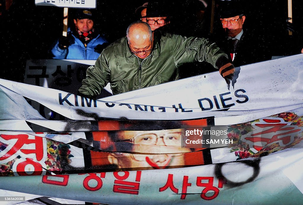 A anti-North Korea protester cuts former