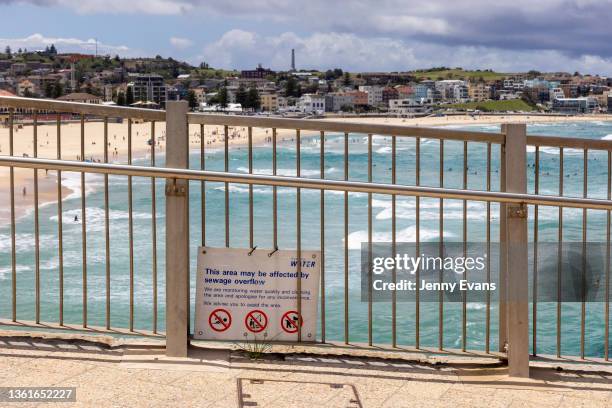 Sign warning of possible sewerage overflow at Bondi Beach on December 29, 2021 in Sydney, Australia. New South Wales has recorded 11,201 COVID-19...