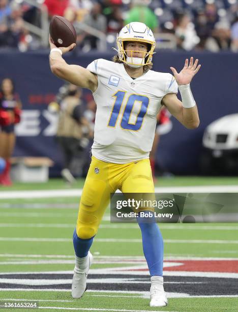 Justin Herbert of the Los Angeles Chargers throws a pass against the Houston Texans at NRG Stadium on December 26, 2021 in Houston, Texas.