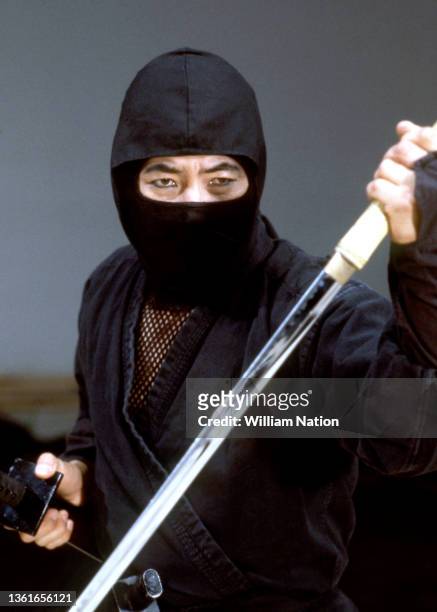 Japanese martial artist, actor, filmmaker and writer Sho Kosugi , poses for a portrait in a ninja outfit, on the set of "Pray for Death" circa 1985...