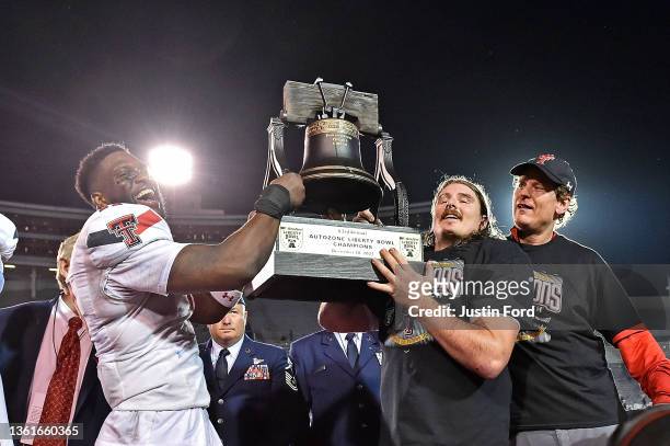 Eric Monroe of the Texas Tech Red Raiders holds the AutoZone Liberty Bowl trophy after defeating the Mississippi State Bulldogs, 34-7 in the AutoZone...