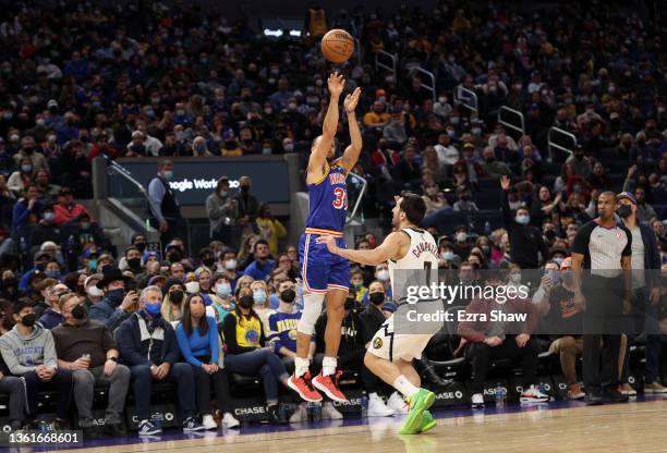 Stephen Curry of the Golden State Warriors makes his 3000th three-point basket with a shot over Facundo Campazzo of the Denver Nuggets in the second...