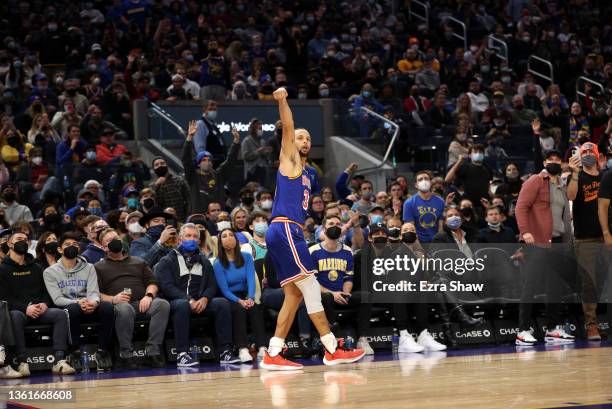 Stephen Curry of the Golden State Warriors watches his 3000th three-point basket go in the basket against the Denver Nuggets in the second half at...