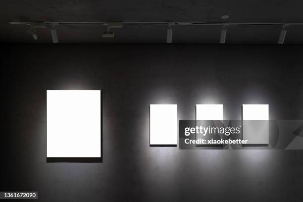 front view of a row of picture frames of different sizes on a concrete wall - empty art gallery stock pictures, royalty-free photos & images