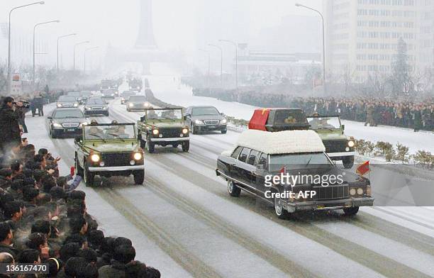 In this photo taken on December 28, 2011 shows a car carrying the casket containing Kim Jong-Il during the funeral procession in Pyongyang. Millions...