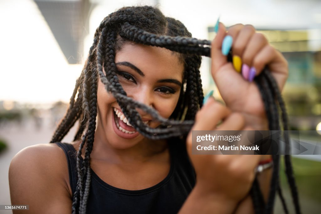 Afro-american teenage model flaunting box braids hairstyle