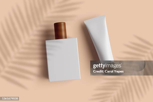 top view white cosmetic plastic bottles on beige background casting shadows - luxury mall bildbanksfoton och bilder