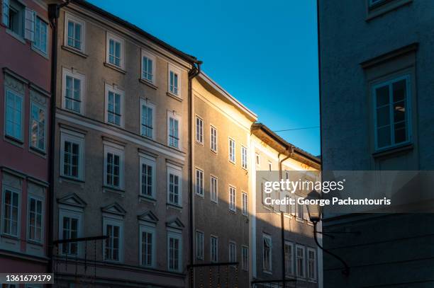 light on a building in the old town of salzburg, austria - saltzburg stock pictures, royalty-free photos & images