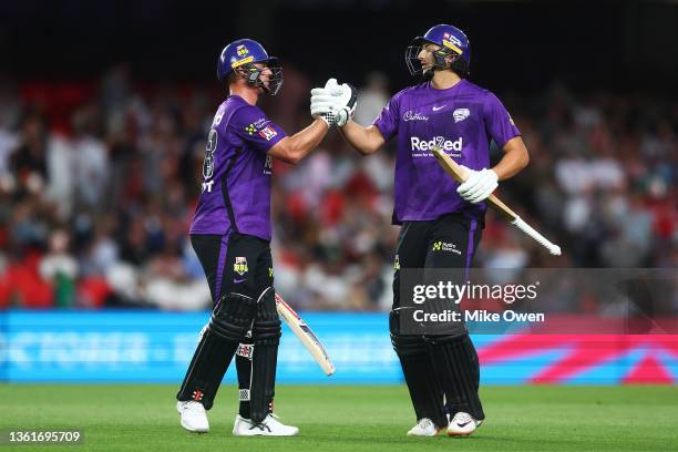 Ben McDermott of the Hurricanes is congratulated on his century after being dismissed by teammate Tim David of the Hurricanes during the Men's Big...