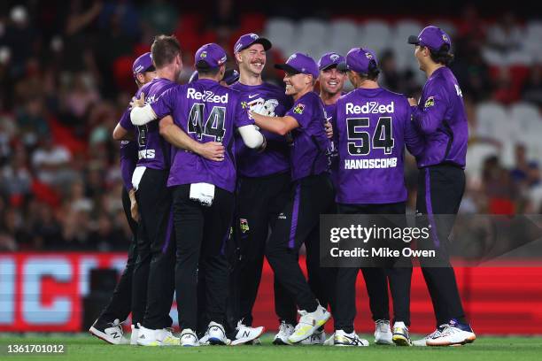 Riley Meredith of the Hurricanes celebrates with teammates after catching out Mackenzie Harvey of the Renegades during the Men's Big Bash League...