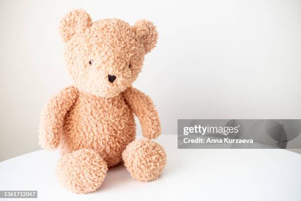 cute teddy bear sitting on a table, selective focus - テディベア　無人 ストックフォトと画像