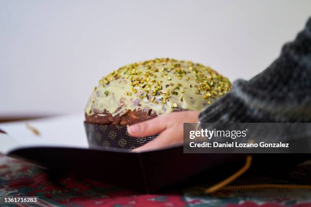 crop woman with panettone sweet bread - panettone stockfoto's en -beelden