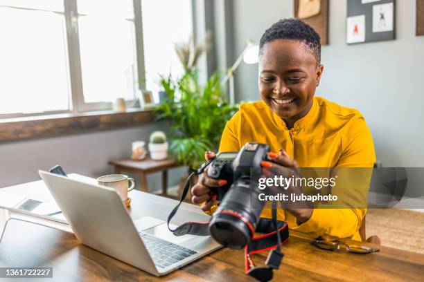 happy young photographer holding a dslr camera - freelancer stockfoto's en -beelden