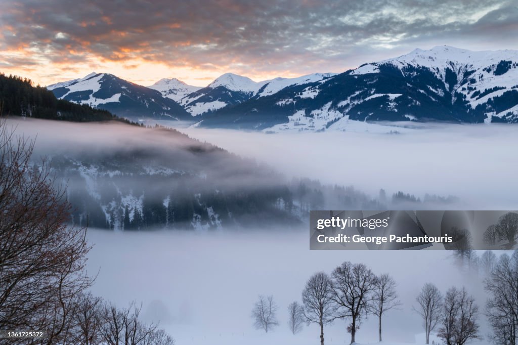 Clouds and mountains during colorful sunset in the Austrian alps