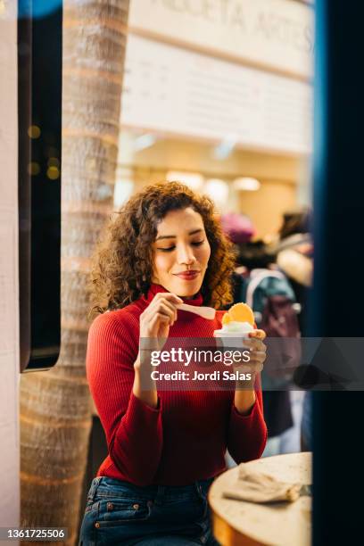 woman eating an ice - barcelona cafe stock pictures, royalty-free photos & images