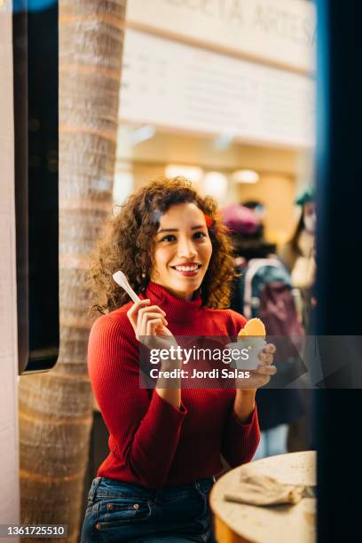 woman eating an ice - woman looking through ice stock pictures, royalty-free photos & images