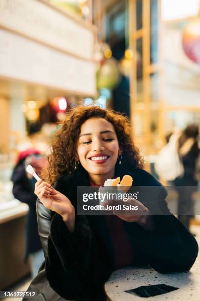 woman eating an ice - woman looking through ice stock pictures, royalty-free photos & images