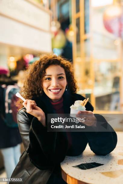 woman eating an ice - woman looking through ice foto e immagini stock