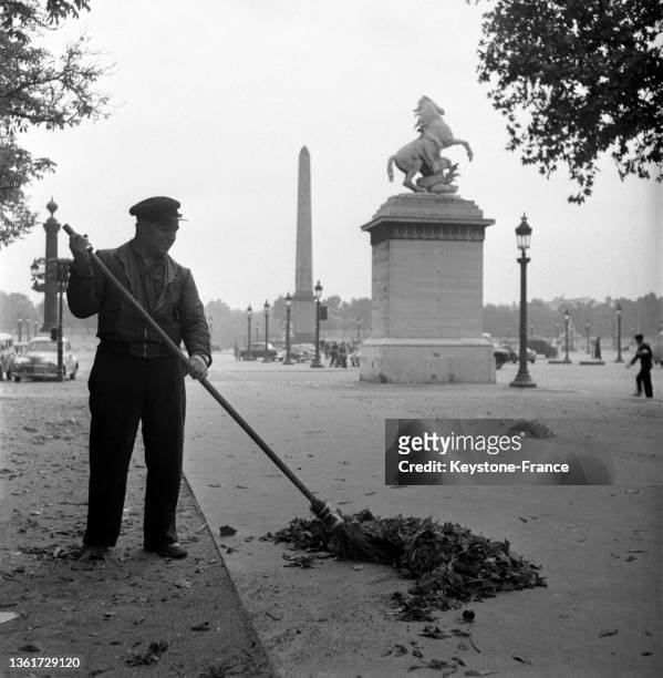 Un agent de propreté nettoie les feuilles près de la place vendôme, le 19 septembre 1952.
