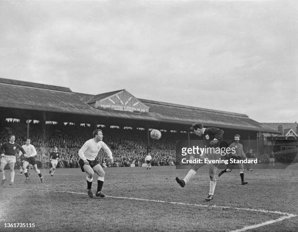 British footballer George Cohen of Fulham as British footballer Jimmy Greaves of Spurs heads the ball during the English Division 1 match between...