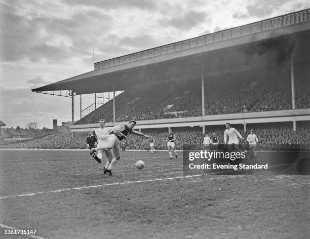 British footballer Dennis Stevens of Everton challenges British footballer Johnny Byrne of West Ham in action during the English Division 1 match...