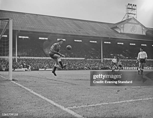 British footballer Pat Jennings in the Spurs goal leaps to gather the ball during the English Division 1 match between Tottenham Hotspur and...