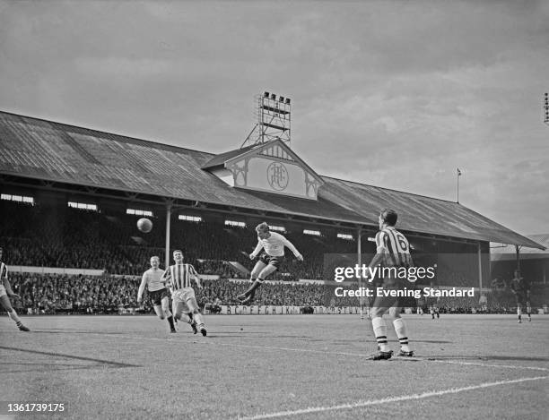 Spurs footballer leaps to head the ball during the English Division 1 match between Tottenham Hotspur and West Bromwich Albion, at White Hart Lane in...