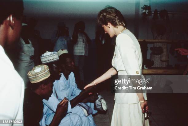 British Royals Diana, Princess of Wales , wearing a Catherine Walker suit, with people during a visit to the Molai Centre, a leprosy hospital and...