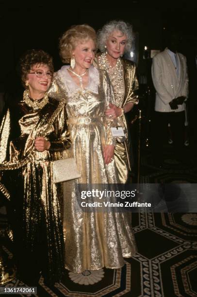 American actress Estelle Getty , American actress Betty White , and American actress Bea Arthur , each dressed in a gold outfit, attend the Night of...