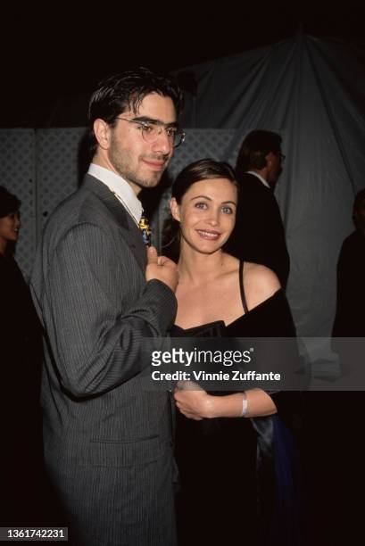 French music producer David Moreau and French actress Emmanuelle Beart, wearing a black-and-blue evening gown, attends the New York premiere of...