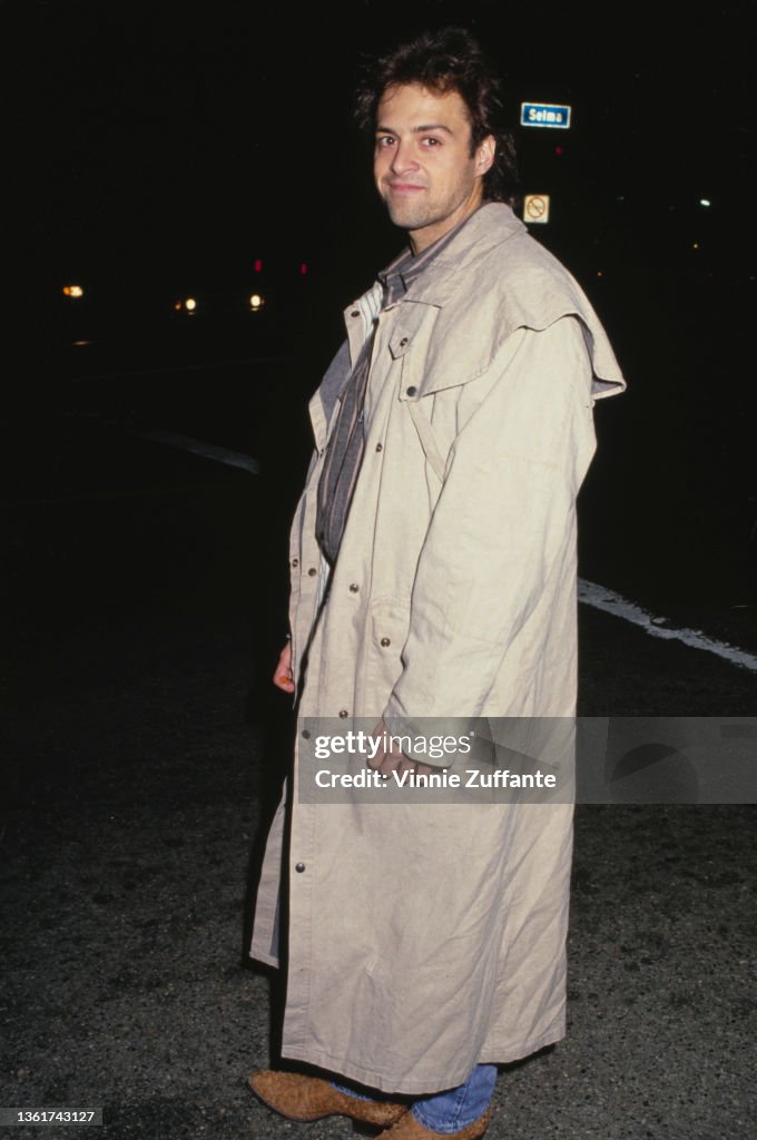 American actor and singer Joseph Gian, wearing a full length beige... News Photo Getty Images
