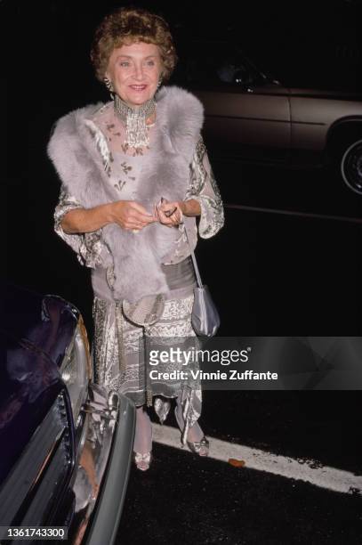 American actress and comedian Estelle Getty , wearing a grey-and-silver outfit with a grey fur stole, attends the 38th Primetime Emmy Awards, held at...