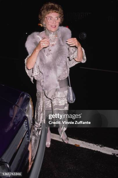 American actress and comedian Estelle Getty , wearing a grey-and-silver outfit with a grey fur stole, attends the 38th Primetime Emmy Awards, held at...