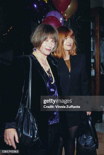 American actress Lee Grant wearing a black coat over a blue velvet top with a long pearl necklace, and her daughter, American actress Dinah Manoff,...