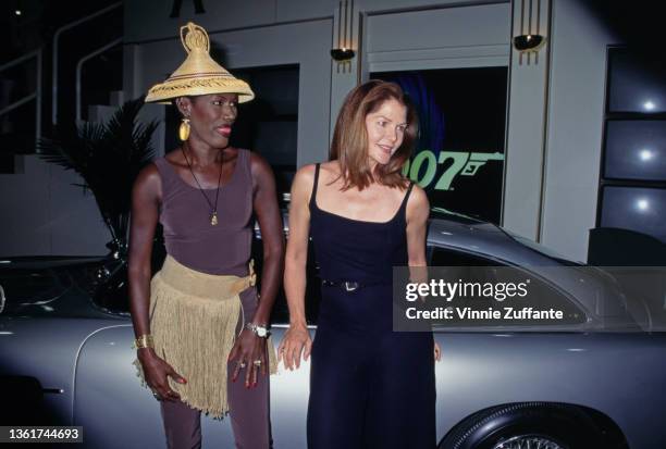 Jamaican-American fashion model, singer and actress Grace Jones, wearing a gold-fringed outfit with an Asian-style conical hat, and American actress...