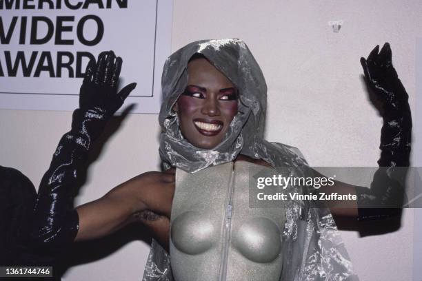 Jamaican-American fashion model, singer and actress Grace Jones, wearing a silver outfit with black evening gloves, attends the 4th Annual American...