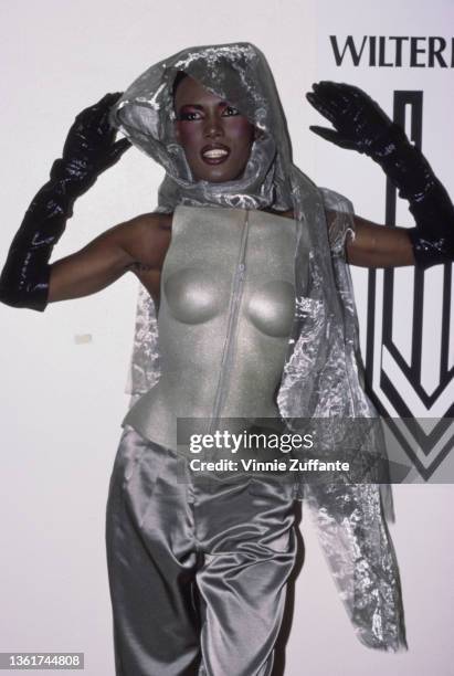 Jamaican-American fashion model, singer and actress Grace Jones, wearing a silver outfit with black evening gloves, attends the 4th Annual American...