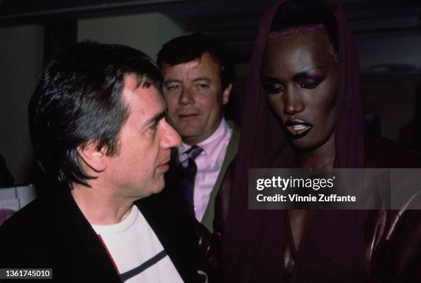 British comedian, actor and pianist Dudley Moore and Jamaican-American fashion model, singer and actress Grace Jones attend a screening party held...