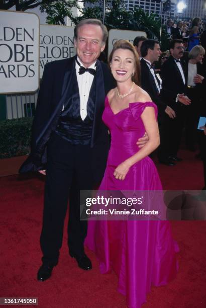 American actor James Keach, wearing a tuxedo and bow tie, and British-American actress Jane Seymour, wearing a pink off-shoulder evening gown, attend...