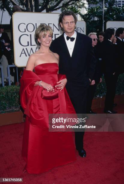 British actress Natasha Richardson , wearing a red evening gown, and her husband, British actor Liam Neeson, wearing a tuxedo and bow tie, attend the...