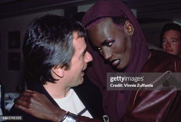 British comedian, actor and pianist Dudley Moore and Jamaican-American fashion model, singer and actress Grace Jones attend a screening party held...