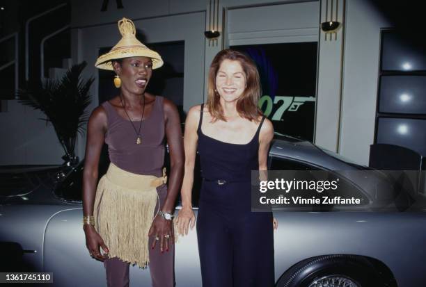 Jamaican-American fashion model, singer and actress Grace Jones, wearing a gold-fringed outfit with an Asian-style conical hat, and American actress...