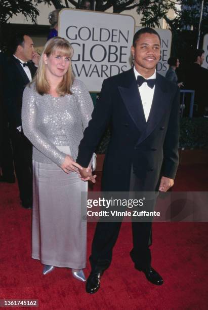 Sara Kapfer, wearing silver outfit, and her husband, American actor Cuba Gooding Jr, wearing a tuxedo and bow tie, attend the 54th Golden Globe...
