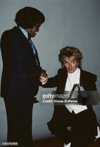 American singer and musician James Brown presents British singer and songwriter Rod Stewart with his 'Hall of Fame' award at the 3rd Annual American...
