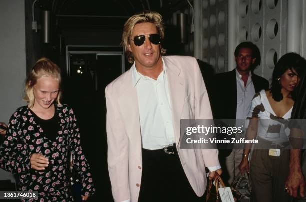 Kimberly Stewart and her father, British singer and songwriter Rod Stewart at Los Angeles International Airport in Los Angeles, California, circa...
