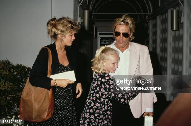 New Zealand model Rachel Hunter with Kimberly Stewart embracing her father, British singer and songwriter Rod Stewart at Los Angeles International...