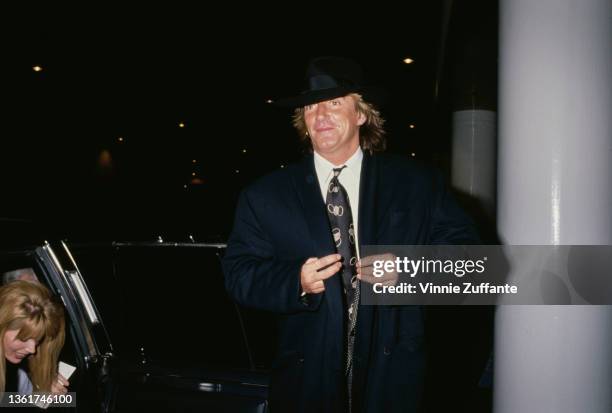 British singer and songwriter Rod Stewart, wearing a fedora and black coat, attends an event at the Carlyle Hotel in New York City, New York, 25th...