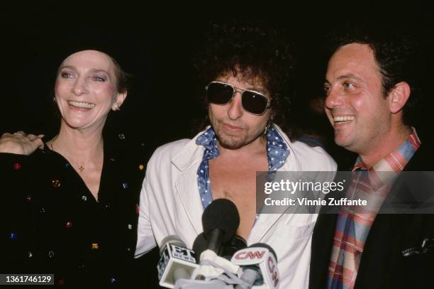 American singer-songwriter Judy Collins, American singer-songwriter Bob Dylan, and American singer, songwriter and pianist Billy Joel attend a party...