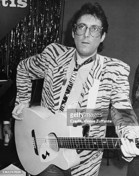 American singer-songwriter Stephen Bishop wearing a tiger print blazer as he performs on an 'Stop Arthritis Telethon, ' organised by the Arthritis...