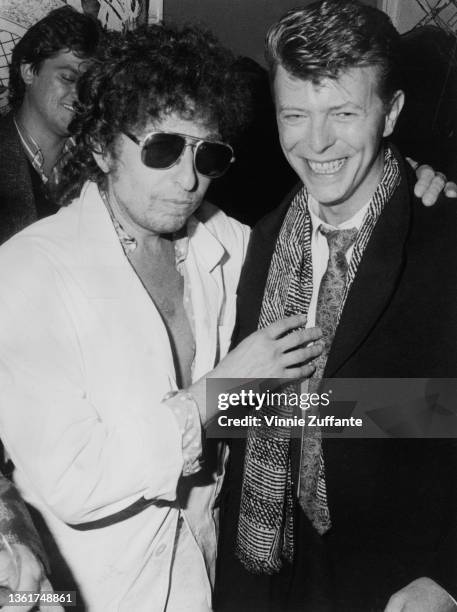 American singer-songwriter Bob Dylan and British singer-songwriter David Bowie attend a party to celebrate the release of 'Biograph,' Dylan's career...